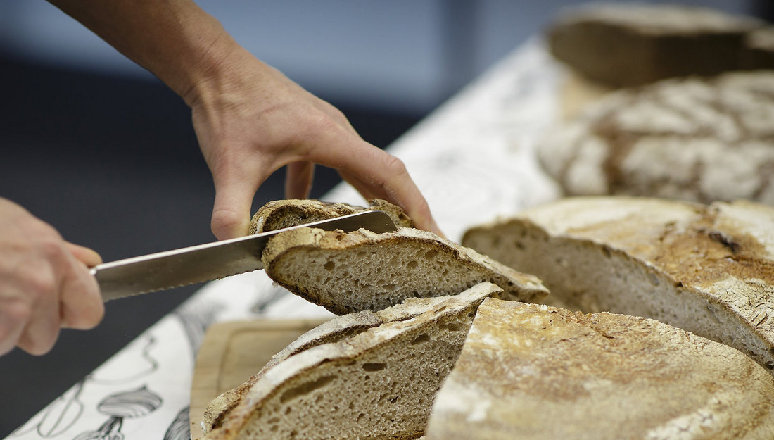 Brot wird in Scheiben geschnitten im Rahmen einer Ich kann kochen! Veranstaltung.